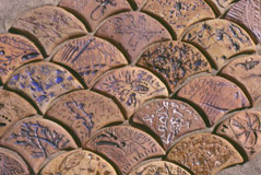 Handmade terracotta tiles for Sam Tubiolo's public art project, Evidence of Life, at Mace Park, in Davis, Ca. 