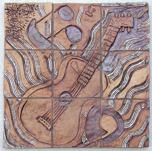 Ceramic tile mural with guitar and music note motif.